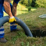 Emptying household septic tank. Cleaning sludge from septic system.