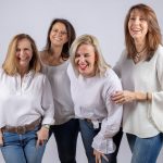 Female executives laughing at joke together