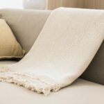 White woven throw blanket on sofa